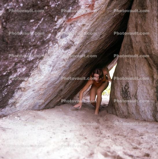 Woman, bikini, rocks, beach, tunnel, 1960s