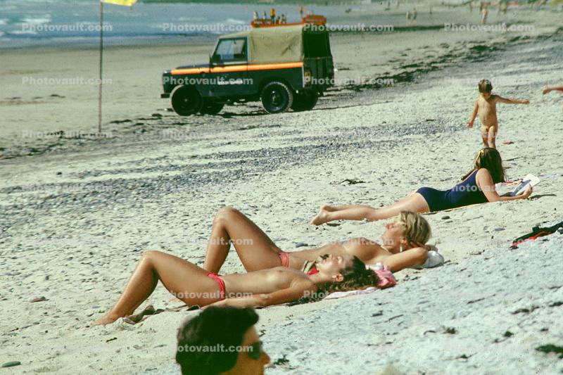 Women Sunning on the Beach, topless, 1970s