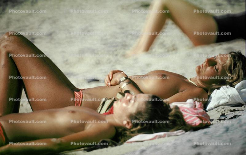 Women Sunning on the Beach, topless, 1970s