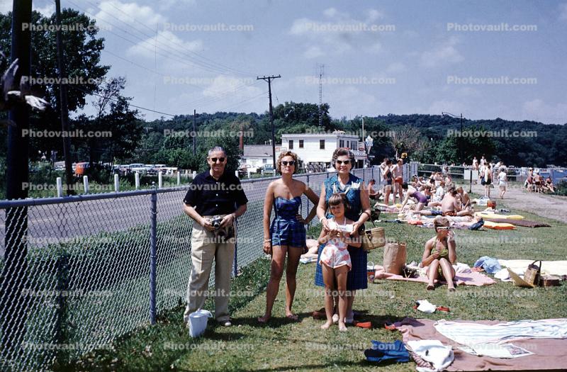 Women, Man, girl, sun worshippers, fence, swimmwear, 1959, 1950s