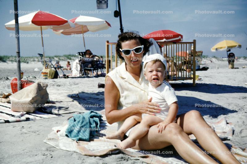 Mother, Cateye glasses, baby boy, parasol, crib, legs, woman, beach towel, 1950s