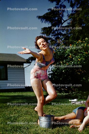 Women, backyard, one piece bathing suit, 1950s