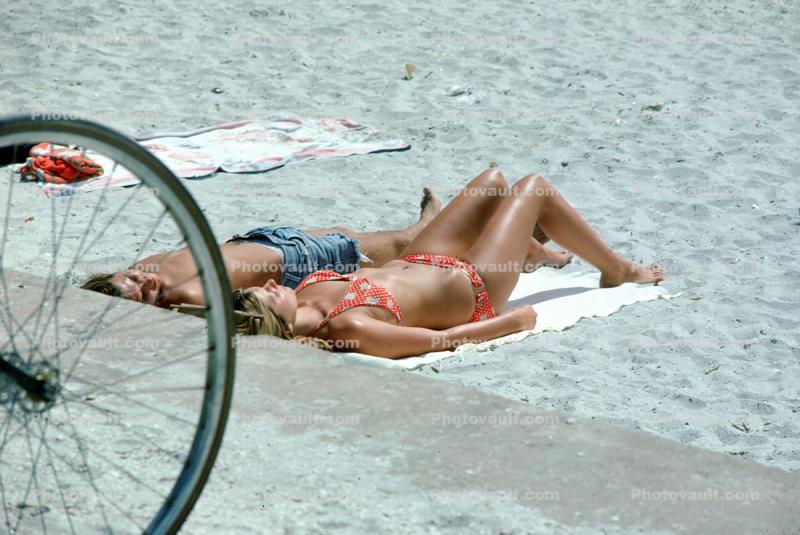 Man and Woman laying in the sun, beach, tanning, sun worshippers