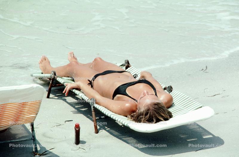 Woman laying in the sun, lounge chair, suntan lotion, beach, tanning, sun worshipper