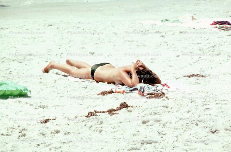 Woman laying in the sun, beach, tanning, sun worshippers