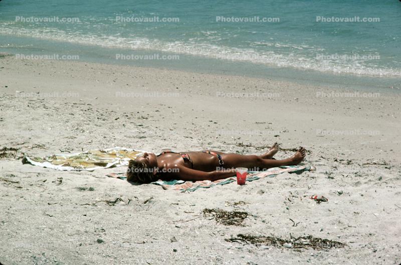 Woman laying in the sun, beach, tanning, sun worshipper