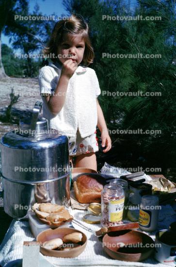 Girl at the Picnic Table, thermos, bread, 1950s