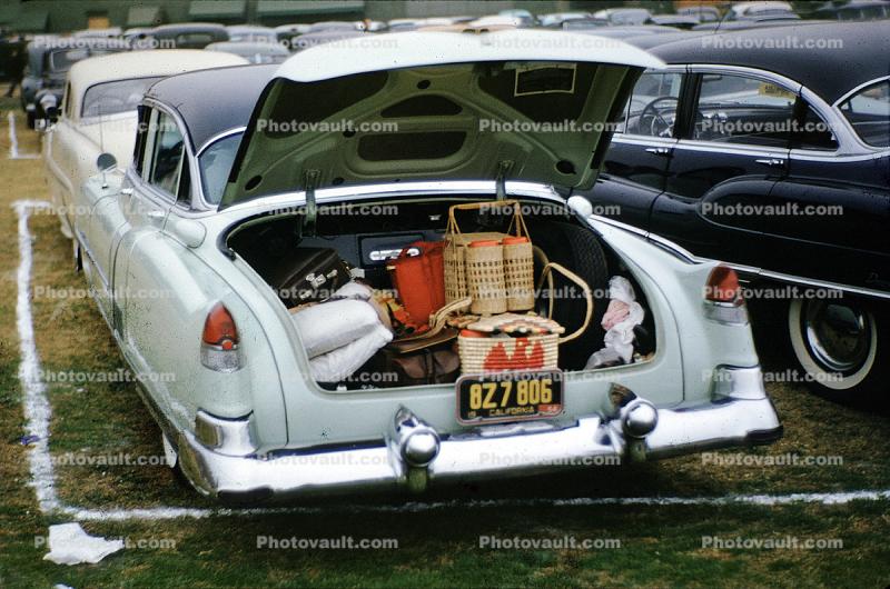 Cadillac, trunk filled with picnic baskets, open trunk, bumper, 1955, 1950s