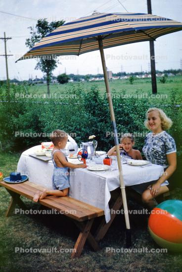 Woman, Boys, Picnic Table, parasol, 1950s