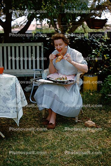 Woman Eating a Drumstick, meat, backyard picnic, 1950s