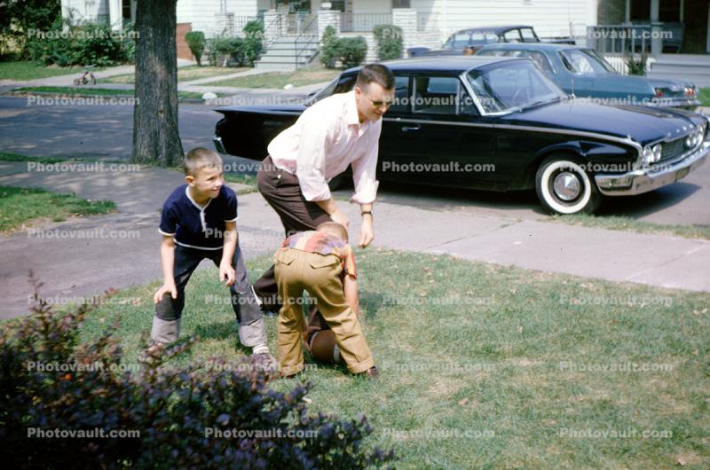Father Playing Football with Sons, Ford Galaxy, 1960s