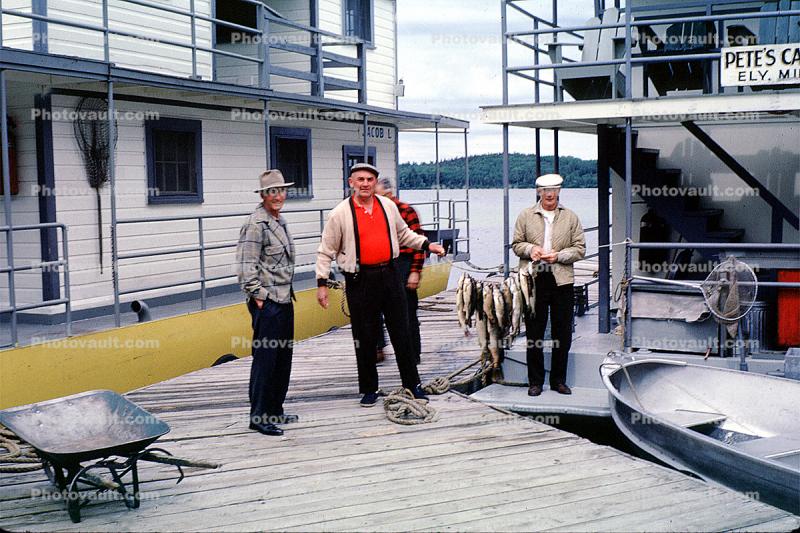 fish catch, men, pier, wheelbarrow, docks, Houseboat, Pete's Cabin Boats, Basswood Lake, Ely, Minnesota, July 1962, 1960s