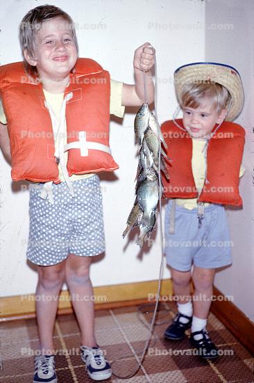 Boys, Fish, smiles, happy, inside, interior, fish catch, Life Preserver, Lifejacket, Lifevest, lifepreservers, life vest, floatation device, 1972, 1970s