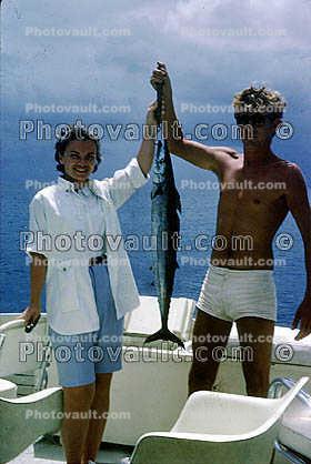 fish catch, man, woman, trunks, Barbados, 1965, 1960s