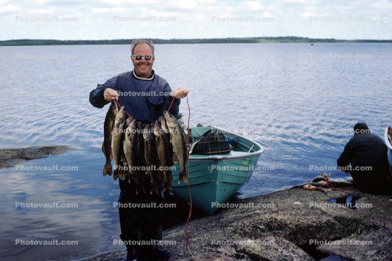 Happy Camper, fish, fisherman, power boat, lake, water, fish catch, man, male, Manitoba, Canada, 1970, 1970s