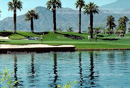 sand trap, water hazard, lake, golfer, golf cart, trees, Palm Desert, California