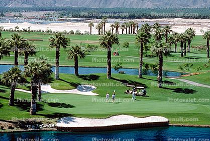 sand trap, water hazard, lake, golfer, golf cart, trees, Palm Desert, California