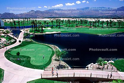 putting green, water hazard, bridge, paths, palm trees, mountain range, Palm Springs