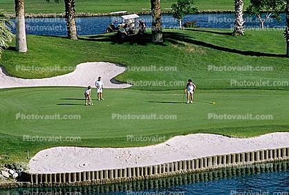 sand trap, water hazard, lake, golfer, golf cart, Palm Desert, California