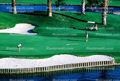 sand trap, water hazard, lake, golfer, golf cart, Palm Desert, California