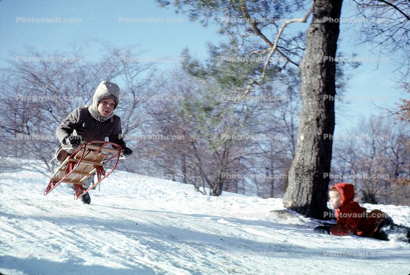 Boy launches into the air on a Sled, Snow, Winter, 1950s