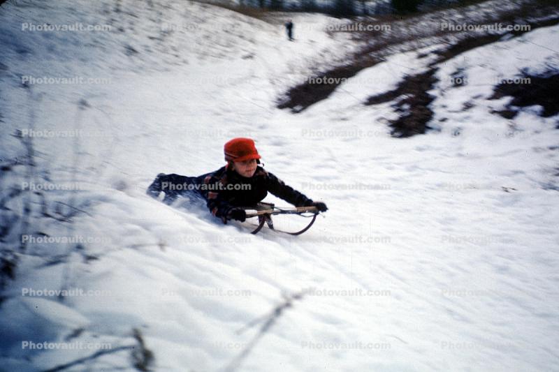 Boy Sledding Downhill in the Snow, 1950s