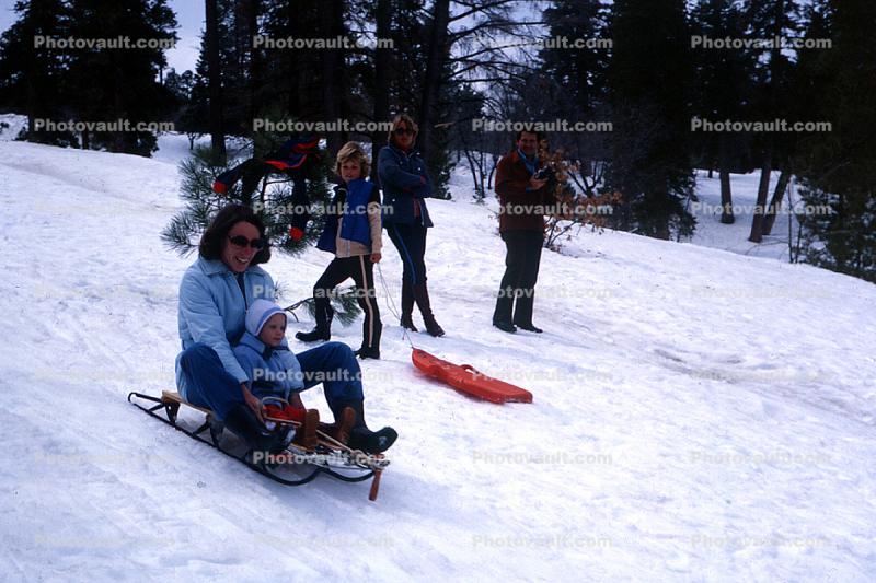 Woman with toddler on a sled