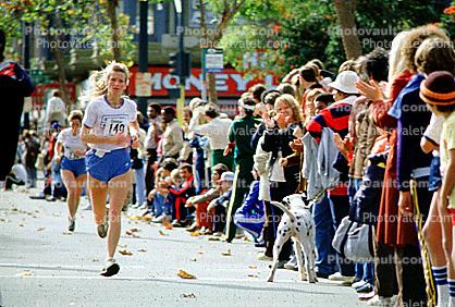 Woman runner, dalmation dog, crowds, spectators, Oakland Half Marathon finish line