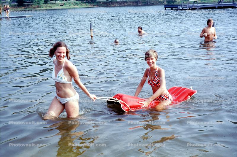 scene with air mattress floating on lake