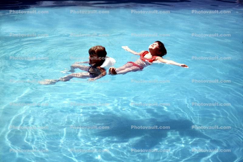Swimming Pool, Floating Boy and Girl, Ripples, Water, Liquid, Wet, Wavelets, 1950s