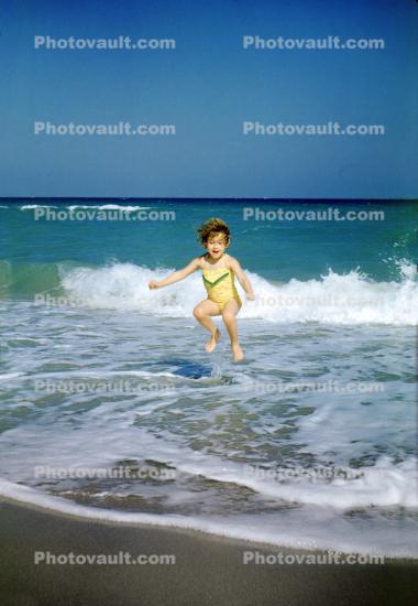 Girl Jumps in the water, ocean, wave, sand, 1950s