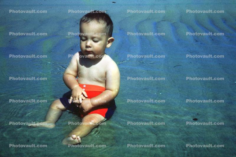 Boy sits in water