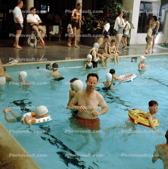 Man in a Swimming Pool, children, floating devices, water