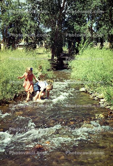 Boy and Girl Wading in a Stream