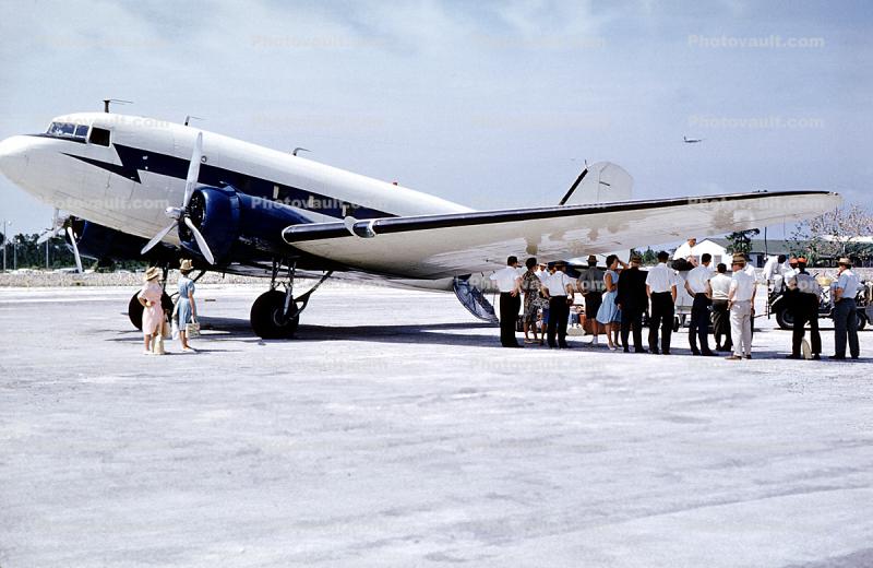 Passengers getting ready to board, men, women, hats, dresses, 1950s
