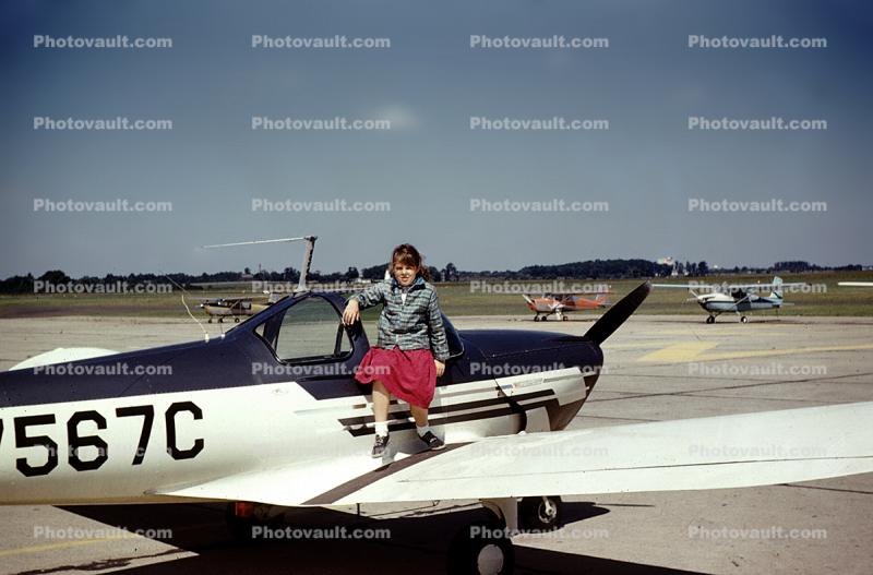 Girl posing on a Forney F-1, N7567C, Pottstown Municipal Airport, September 1960