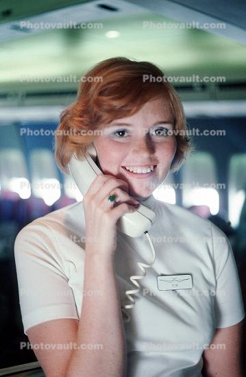 Stewardess on the intercom, Flight Attendant, Cabin Crew, Hostess, October 1975, 1970s