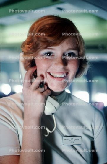 Stewardess on the intercom, Smiles, Teeth, hand, Phone, Flight Attendant, Cabin Crew, 1975, October 1975 1970s