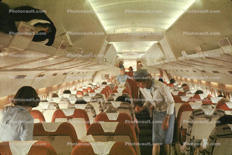 Stewardess, Cabin Crew, overhead bins, luggage, seats