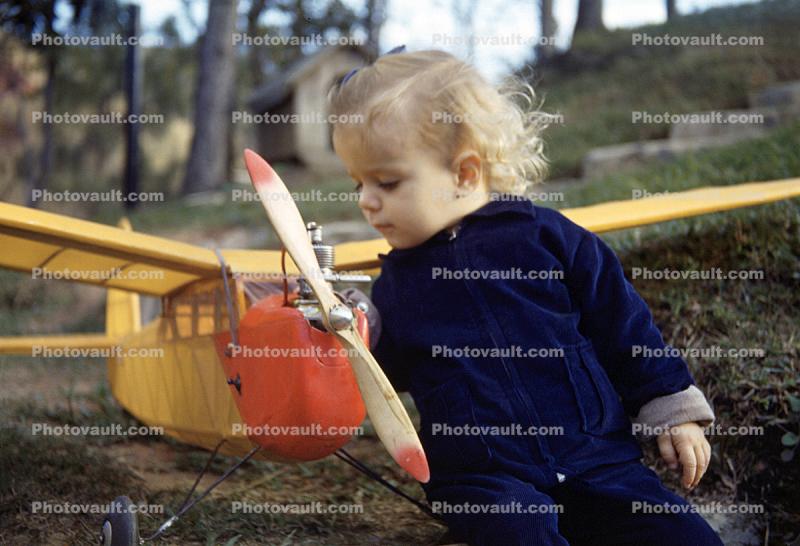 Little Girl with a Balsa Wood airplane, backyard, 1950s