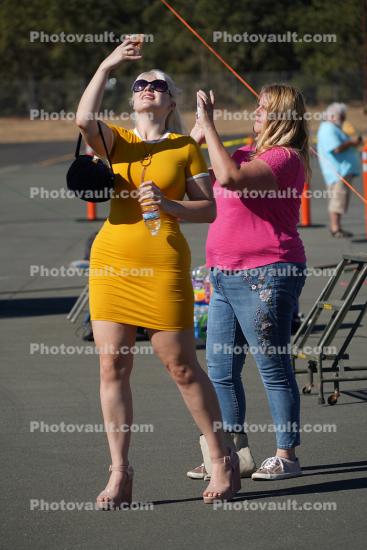 Women doing selfies at airshow