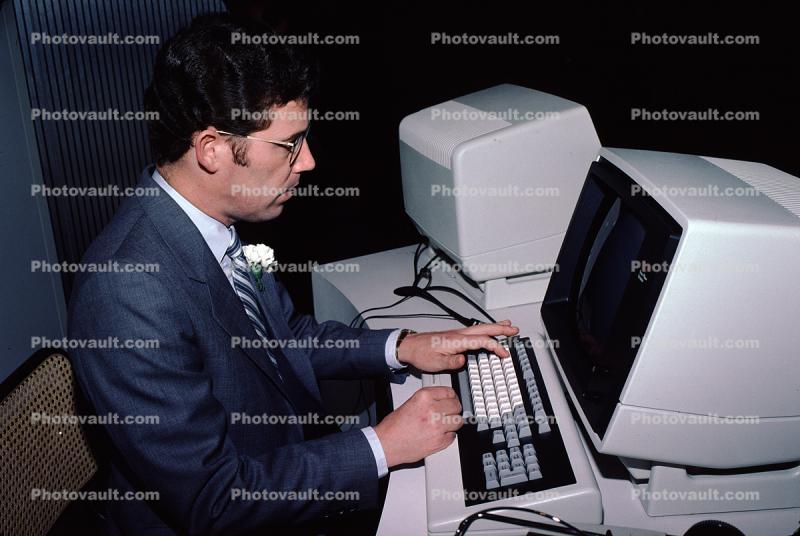 Four-Phase Systems Computer, Hand on Keyboard, Man at Computer, April 1982