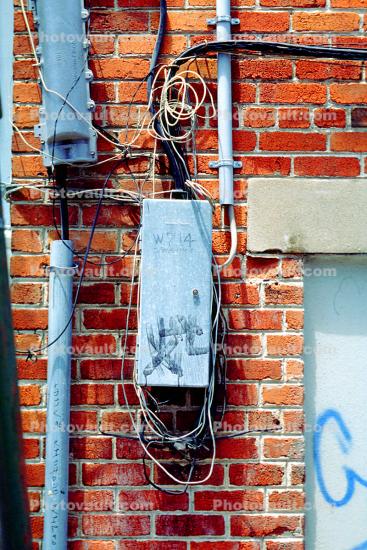 Electrical Distribution Mess, brick wall