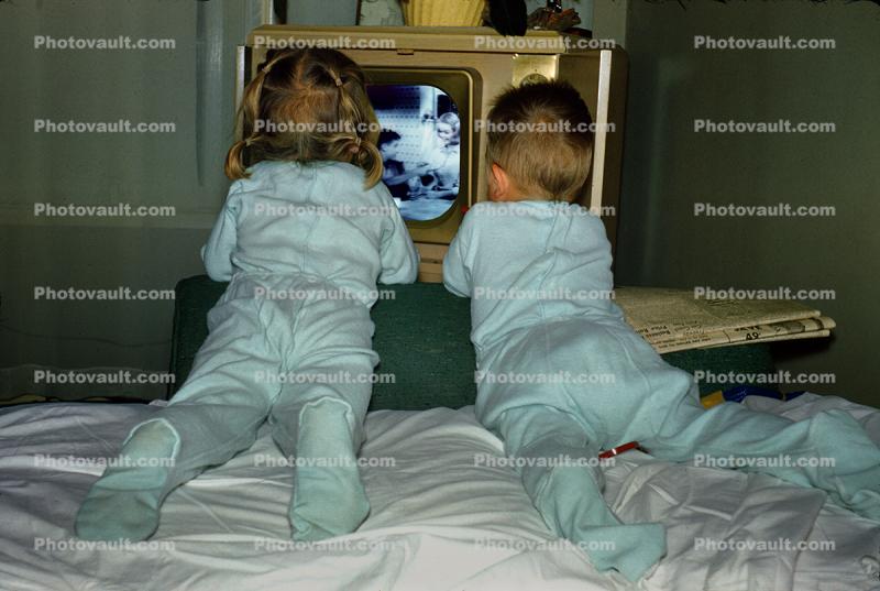 Girl and Boy watching television in the 1950s