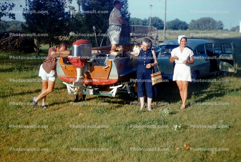 1956 Chevy Bel Aire towing a small boat, Outboard Motor, 1950s