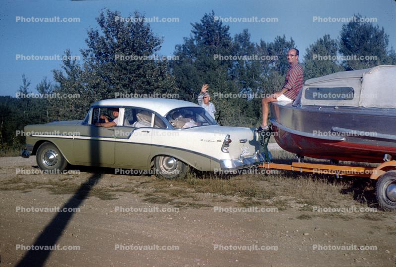 1956 Chevy Bel Aire towing a small boat, Outboard Motor, 1950s