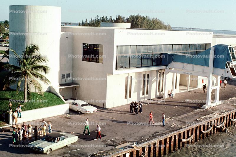 Cruise line building, cars, automobiles, vehicles, dock, 1960s