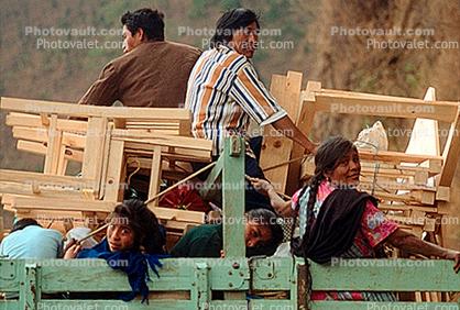 overcrowded truck, people, furniture