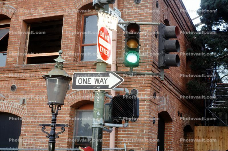 One Way Sign, Stop Light, lamp, brick building