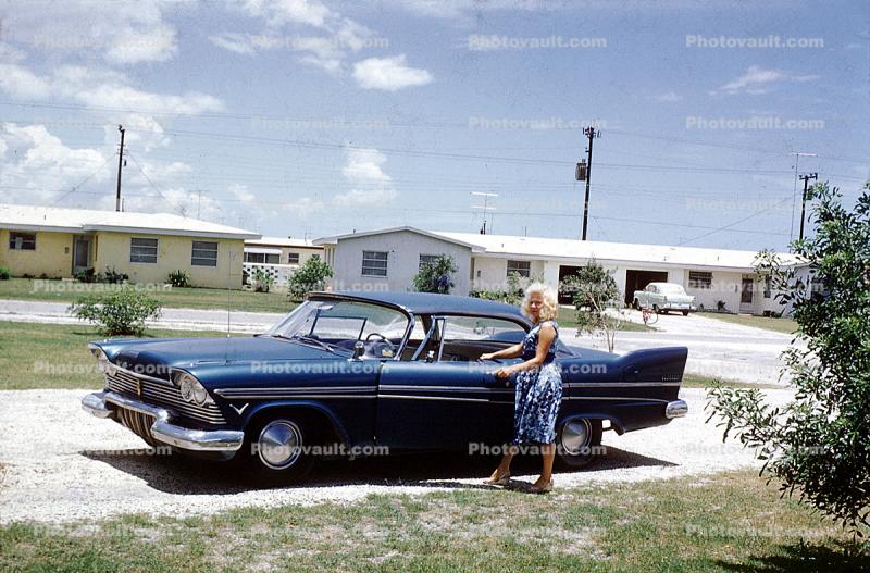 1958 Plymouth Fury, tail fins, woman opens door, suburbia, 1950s